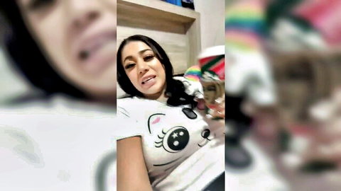 Giselle Montes smiling playfully in cute cat t-shirt, dark ponytail hair