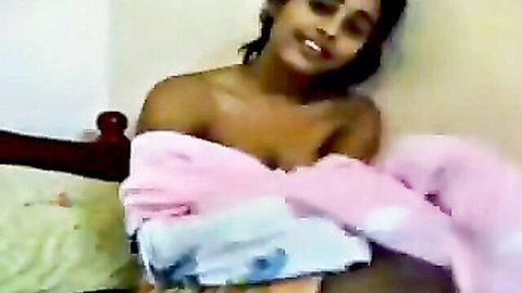Smiling Indian woman topless in slipping pink towel, teasing exposure