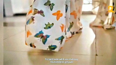 Desi woman in colorful butterfly pants teasing from behind