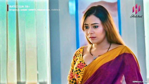 Indian woman in yellow saree with cleavage, emotional gaze in HulChul web series