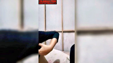 Indonesian woman in white jilbab intimately touched by lover