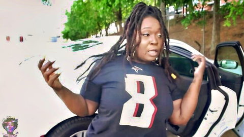 Gibby The Clown, curvy black model in Houston Texans jersey posing by car