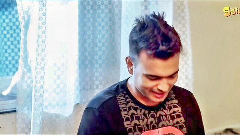 Smiling Indian man with spiky hair holding guitar in casual black shirt