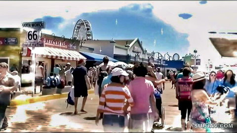 Crowded Santa Monica Pier boardwalk scene with beachgoers and Ferris wheel