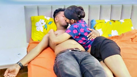 Shirtless Indian hunk passionately kissing curvy brunette babe in bed during steamy foreplay