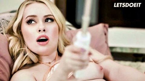 Serene Siren blonde MILF topless holding white vibrator open mouth
