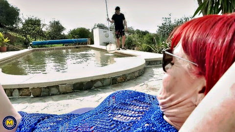 John Luna mature redhead lounging in sexy blue crochet by pool