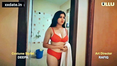 Indian cougar in red lingerie posing seductively in bathroom doorway