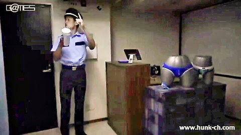 Security guard sips drink next to big gray ass mannequins in tight blue briefs