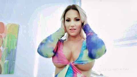 Curvy blonde with massive exposed tits smiling playfully hands in hair
