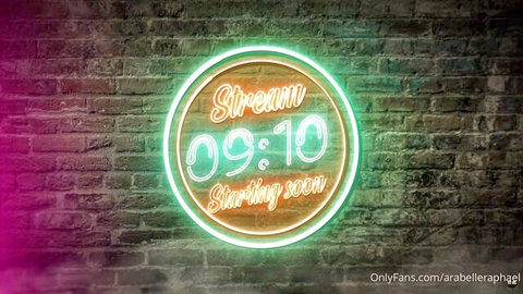 Neon 'Stream 09:10 Starting Soon' sign glowing on brick wall for OnlyFans @arabellaph live show
