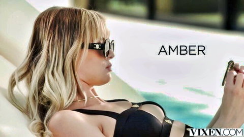 Amber Moore in revealing black bikini, lounging poolside seductively