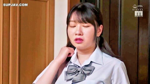Cute Japanese schoolgirl in uniform touching neck with pouty lips and glossy eyes