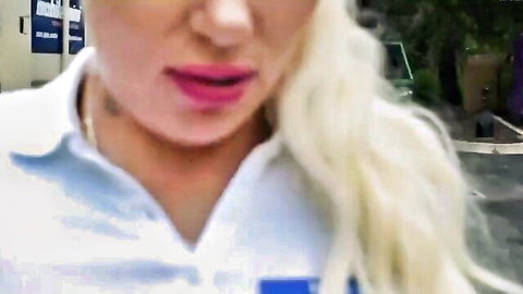 Closeup of sexy blonde MILF puckering plump lips in white collared shirt outdoors