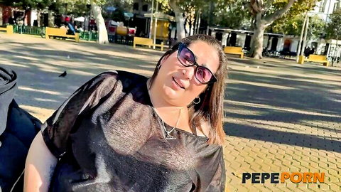 Curvy mature woman in sheer black top teasing big tits outdoors in sunny park