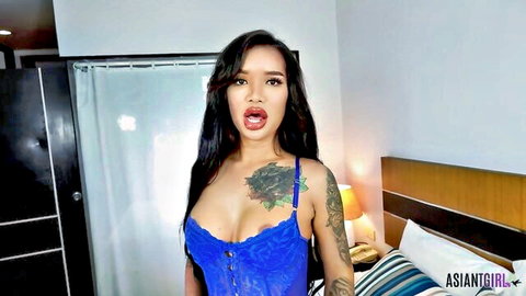 Stunning Asian ladyboy in blue lace lingerie, seductive pose
