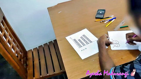 Ayesha Madhushani sketching at desk, innocent art session