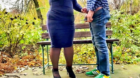 Curvy mom in tight dress and stockings with young guy touching her thighs outdoors