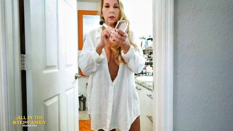 Blonde MILF housewife teases deep cleavage and big tits in open white shirt bathroom selfie