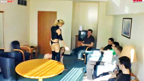 Blonde babe in black thong bends over showing juicy ass to group of watching men