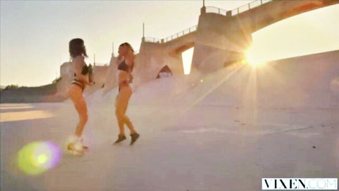 Riley Reid and Teanna Trump in skimpy bikinis walking on sunny beach