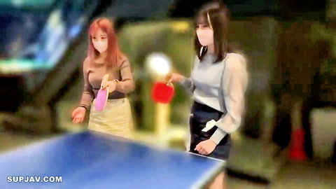 Two masked Asian women in skirts playing table tennis sensually