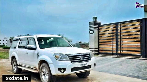 White Ford Everest SUV parked outside modern gated residence in India