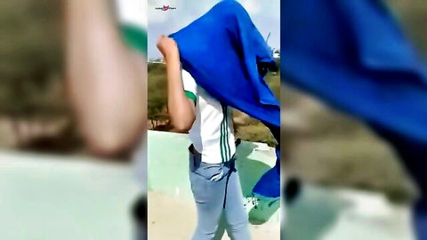 Beautiful Indian girl in white top and jeans on terrace, teasing nude reveal