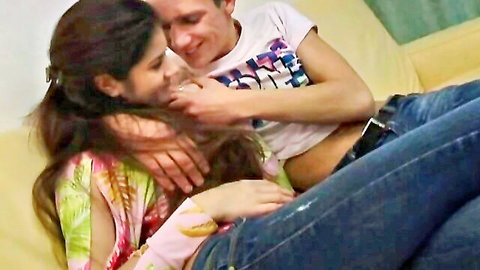 Passionate Indian couple making out on couch, starting hot sex session