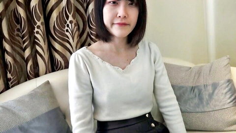 Japanese amateur woman in white V-neck sweater and black button skirt, solo pose