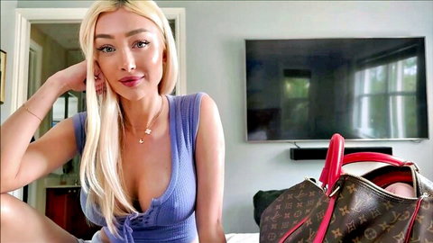 Frances Bentley in low-cut blue top, blonde hair, deep cleavage tease