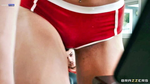 Ariana Starr in red swimsuit with man between her legs, oral tease