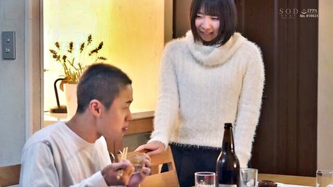 Japanese woman in fluffy white sweater smiles at man eating dinner in cozy JAV scene