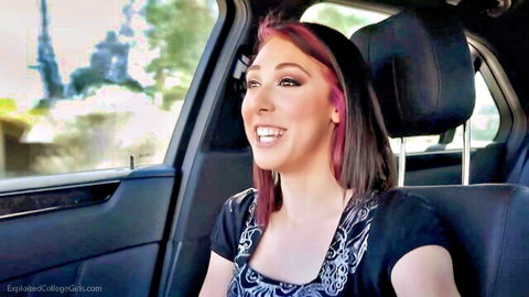 Hanna smiling in car from ExCoGi HD video, pink hair and black top