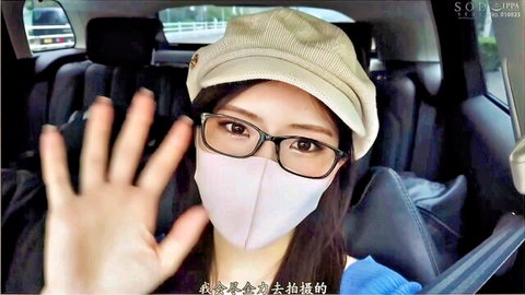 Asian woman in glasses mask and cap waving hand from car backseat