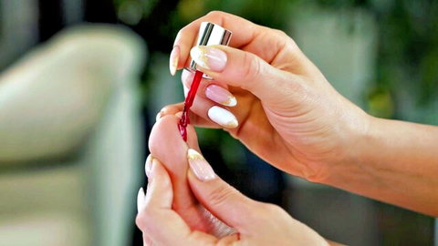Leya Desantis applies red nail polish to toes, foot fetish tease