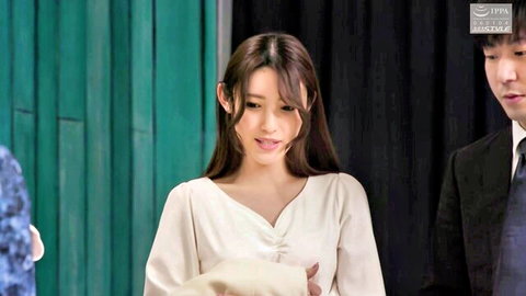 Asian couple in formal attire, woman in white dress looking surprised
