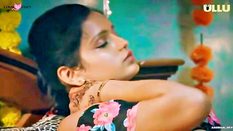 Desi Indian MILF in pink floral dress posing seductively in Ullu web series