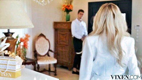 Blonde bombshell in shiny white dress teases suited man from behind in luxury hotel room