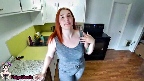Paige Steele as squirt-hungry redhead housewife in gray tank top