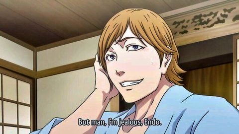 Blond anime guy in blue yukata smiling jealously on phone in Japanese room