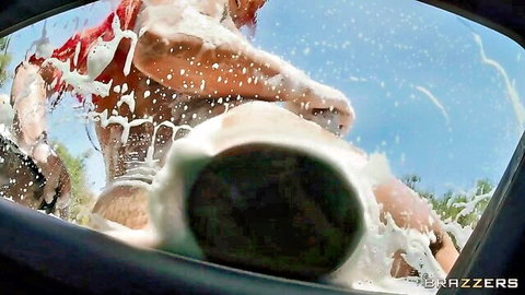 Tanned redhead with big tits soaps huge black cock through car window at outdoor car wash
