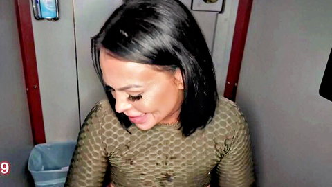 Curvy black woman in tight mesh top teasing with open mouth in gloryhole stall