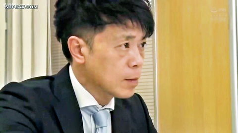 Japanese boss in black suit talking in office setting