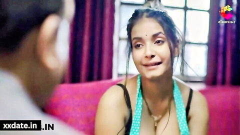 Indian beauty in low-cut green blouse smiling seductively