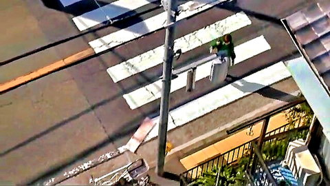 Japanese woman in green shirt walking crosswalk in peeping affair JAV scene