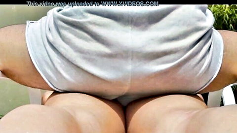 Asian woman in tight white shorts spreading legs wide, teasing cameltoe view