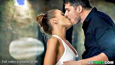 Petite ballerina in white tank top passionately kissing muscular man