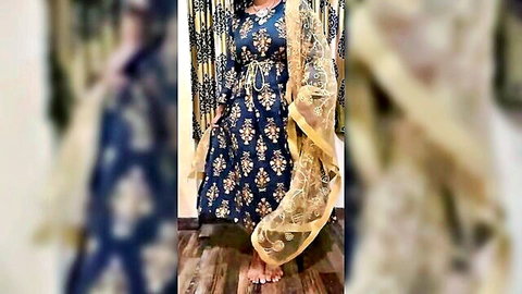 Sexy Indian MILF cougar posing solo in embroidered navy blue dress with golden dupatta teasing curves