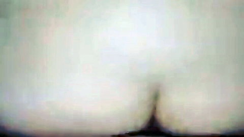 Blurry close-up of pale woman's large ass in explicit anal pose
